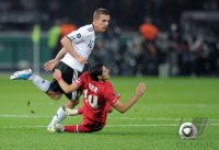 Fussball International EM 2012-Qualifikation:  Lukas PODOLSKI (li, Deutschland) gegen Oezer Hurmaci (re, Tuerkei)
