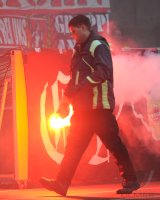 Fussball 1. Bundesliga, Saison 2011/2012:  Koeln Fankurve mit einem Bengalischen Feuer zum Fasching