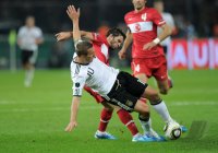 Fussball International EM 2012-Qualifikation:  Lukas PODOLSKI (li, Deutschland) gegen Goekhan Goenuel (re, Tuerkei)