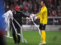 Fussball 1. Bundesliga : Torwart Raphael Schaefer (1 FC Nuernberg) muss die Papierrollen aus dem Strafraum entfernen welche die Bayern Fans geworfen haben