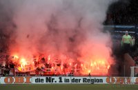 Fussball 1. Bundesliga, Saison 2011/2012:  Koeln Fankurve mit einem Bengalischen Feuer zum Fasching