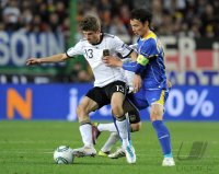 Fussball International EM 2012-Qualifikation: Thomas MUELLER (li, Deutschland) gegen Kairat Nurdauletov (re, Kasachstan)